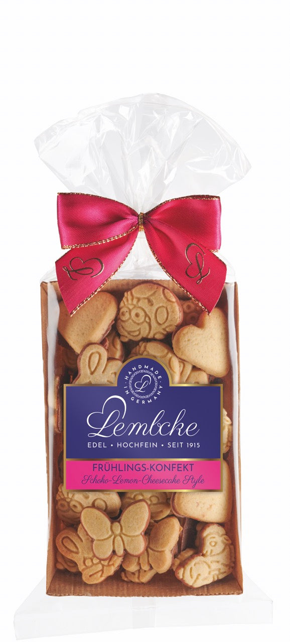 Frühlings-Konfekt Schoko Lemon Cheesecake Style von Lembcke – Mini-Mürbegebäck mit Zitronennote und Vollmilchschokolade, erhältlich in der Dreyer Confiserie in der Rattenfängerstadt Hameln.