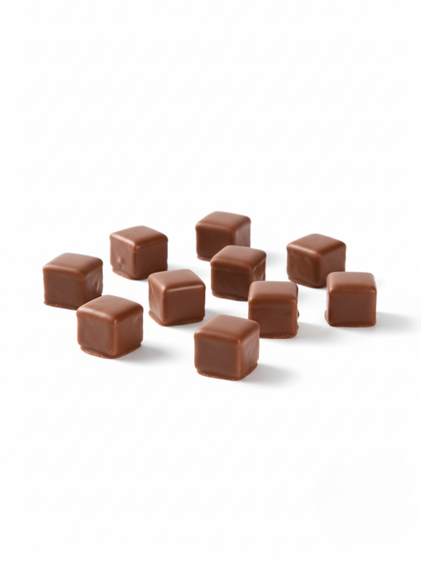 Dominosteine Vollmilch 125 g – feine Würfel aus Lebkuchen, Gelee und Marzipan, umhüllt von zarter Vollmilch-Schokolade, erhältlich in der Dreyer Confiserie in der Rattenfängerstadt Hameln.