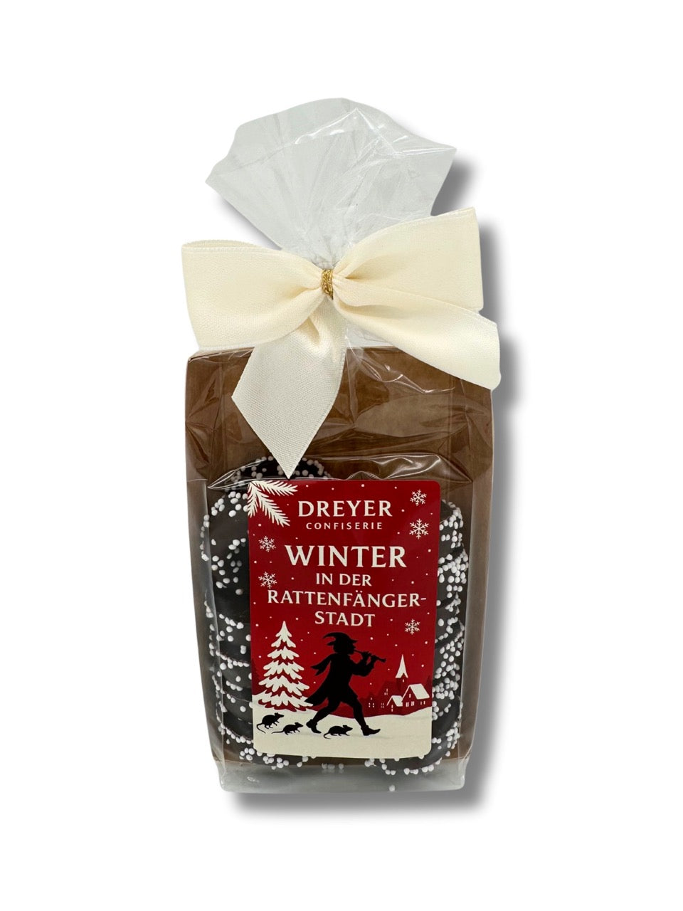 Creme Ringe 125 g mit Aufdruck „Winter in der Rattenfängerstadt“, handverpackt mit cremefarbener Schleife, erhältlich in der Dreyer Confiserie in der Rattenfängerstadt Hameln.