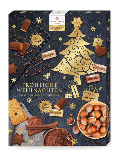 J.G.N. Adventskalender Nougat 500g von Niederegger mit 24 Türchen, dunkelblauem Design, goldenem Weihnachtsbaum, Haselnüssen, Nougatpralinen und Schriftzug „Fröhliche Weihnachten“