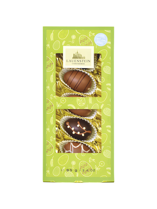 Oster Klarsichtpräsent Manufaktur Ei Auslese 95g von der Lauenstein Confiserie, fünf handdekorierte Ostereier ohne Alkohol in transparenter Geschenkverpackung, erhältlich bei der Dreyer Confiserie in Hameln.