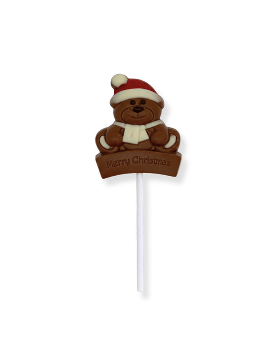 Schokoladen Weihnachts Lolli „Bär“ 30g –von Meynendonckx weihnachtlicher Schokoladen-Lolli in Bärenform aus Vollmilchschokolade mit farbiger Dekoration, erhältlich in der Dreyer Confiserie in der Rattenfängerstadt Hameln.