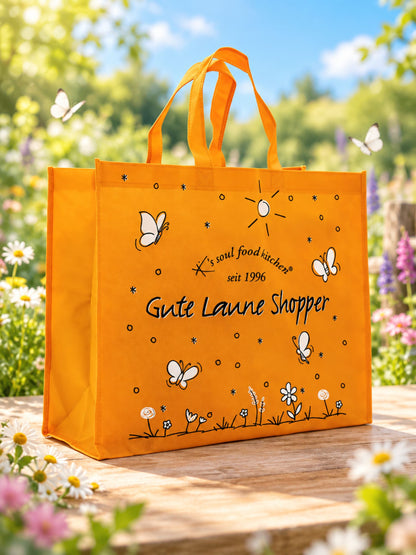 Oranger Gute Laune Shopper von K's Soul Food Kitchen mit Schmetterlingen und Blumen