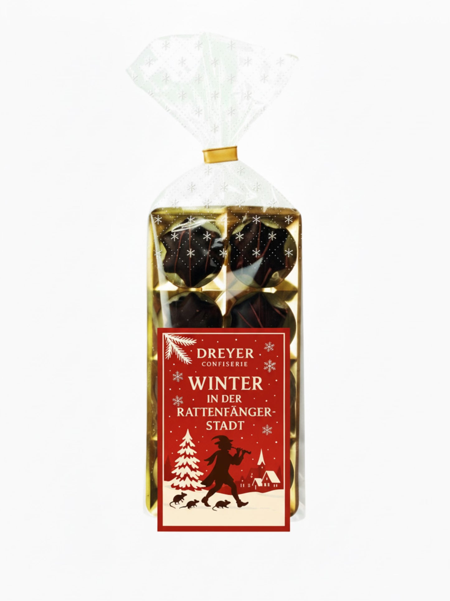 Verpackung von Orangenlikör-Sterne Kruste 100 g – feine Sterne aus Bitterschokolade mit flüssiger Orangenlikör-Füllung, edel verpackt, erhältlich in der Dreyer Confiserie in der Rattenfängerstadt Hameln.