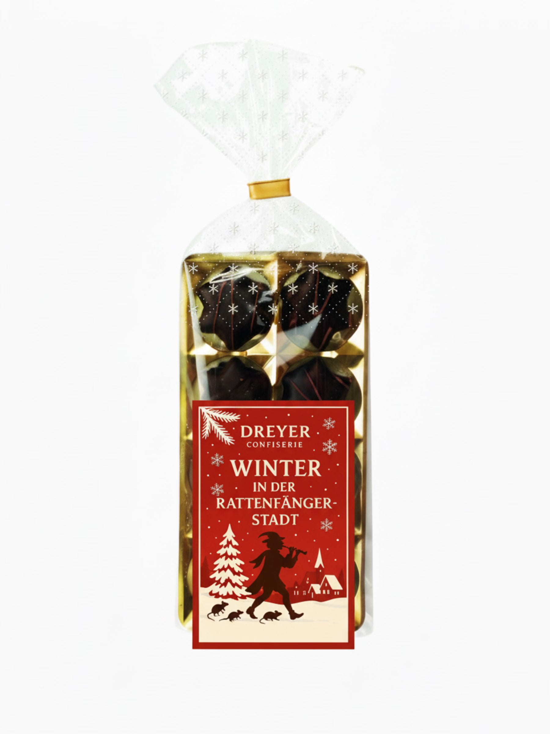 Verpackung von Orangenlikör-Sterne Kruste 100 g – feine Sterne aus Bitterschokolade mit flüssiger Orangenlikör-Füllung, edel verpackt, erhältlich in der Dreyer Confiserie in der Rattenfängerstadt Hameln.