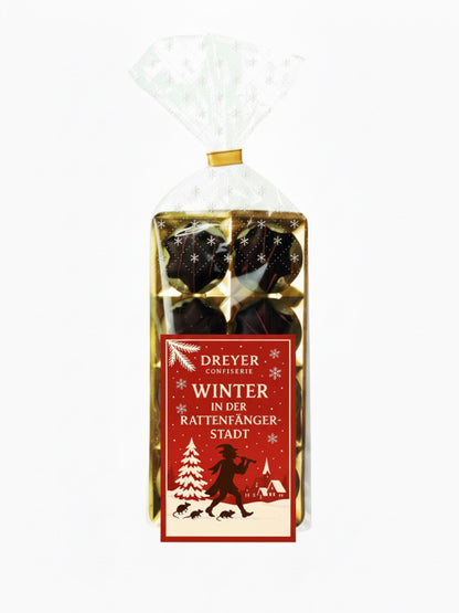 Verpackung von Orangenlikör-Sterne Kruste 100 g – feine Sterne aus Bitterschokolade mit flüssiger Orangenlikör-Füllung, edel verpackt, erhältlich in der Dreyer Confiserie in der Rattenfängerstadt Hameln.