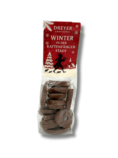 Verpackung von Schokospritzringe Zartbitterschokolade 100 g – edle Ringe aus kräftiger Zartbitterschokolade, handverpackt von der Dreyer Confiserie in der Rattenfängerstadt Hameln.