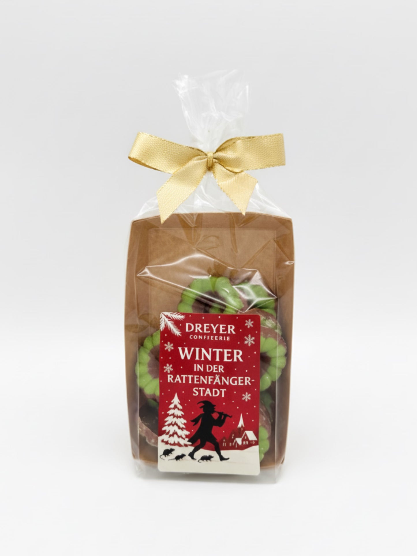 Verpackungsbild von Produktfoto von X-Mas Schokoringe Vollmilch grün 100 g – feine Vollmilchschokolade mit weihnachtlicher Deko, erhältlich bei der Dreyer Confiserie in Hameln.