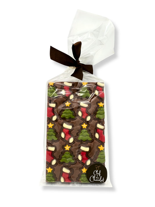Weihnachten Schokoladentafel Vollmilch 150g von der von Ham Chocolaterie – weihnachtlich dekorierte Vollmilchschokoladentafel mit Baum-, Stern- und Stiefelmotiven, erhältlich in der Dreyer Confiserie in der Rattenfängerstadt Hameln.